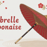 Ombrelle japonaise rouge dorée posée fond zen